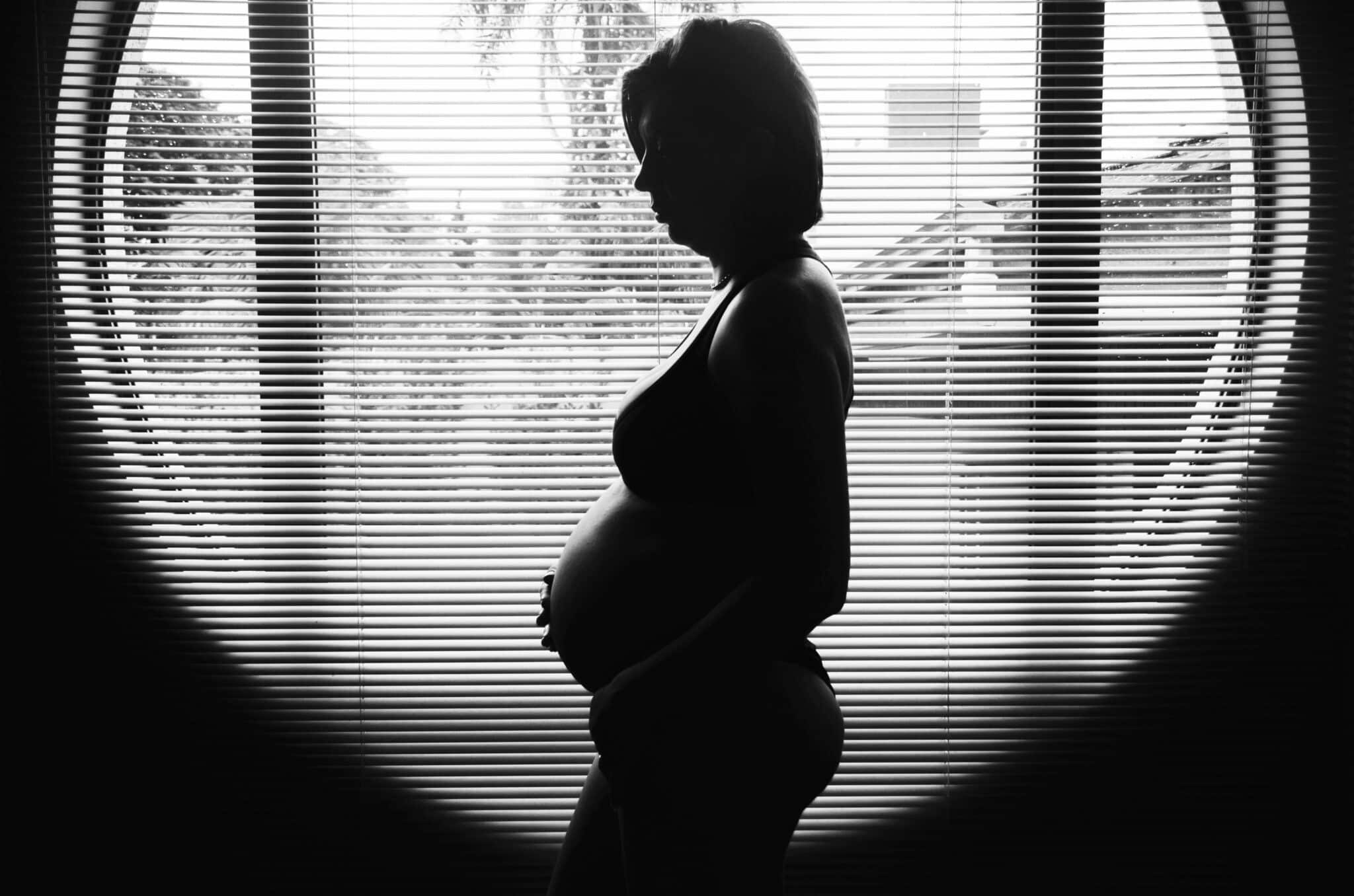 pregnant woman sitting with big windows