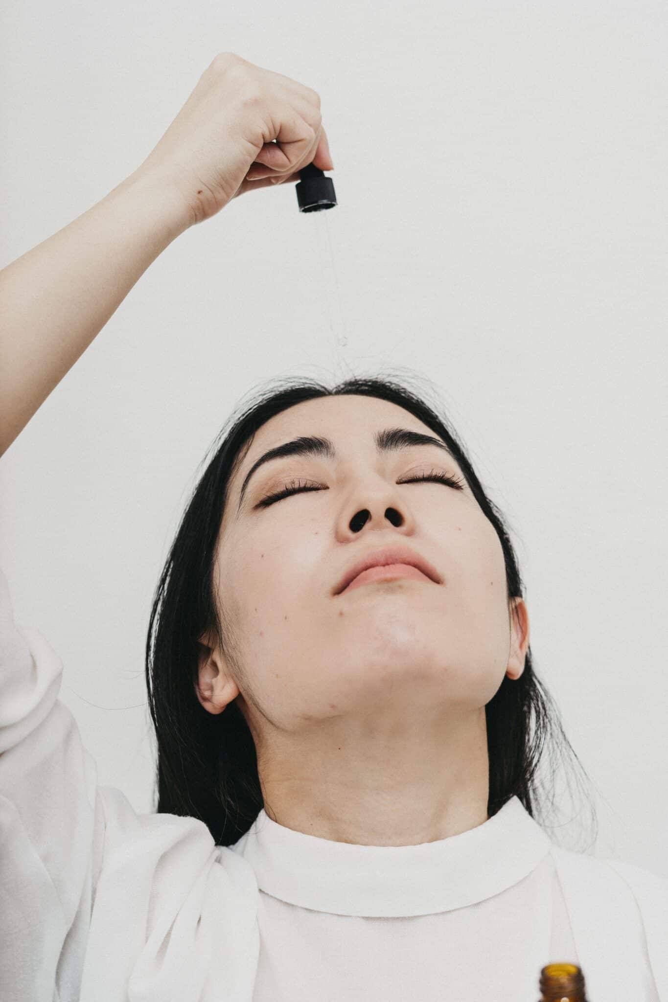 woman applying coconut oil on her face